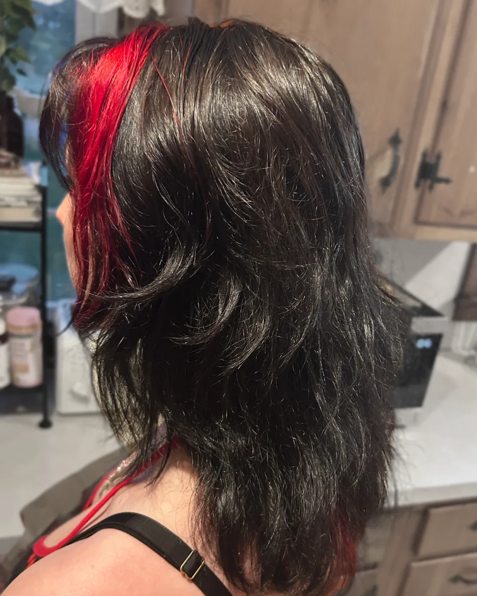 Dark brunette shag with red peekaboo at the face frame