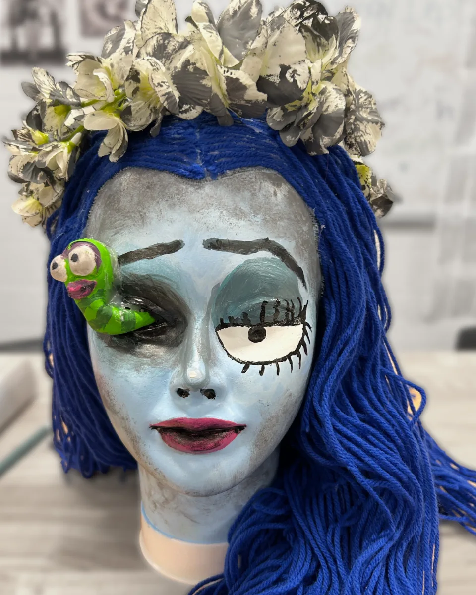 Character makeup build with painted features and yarn hair