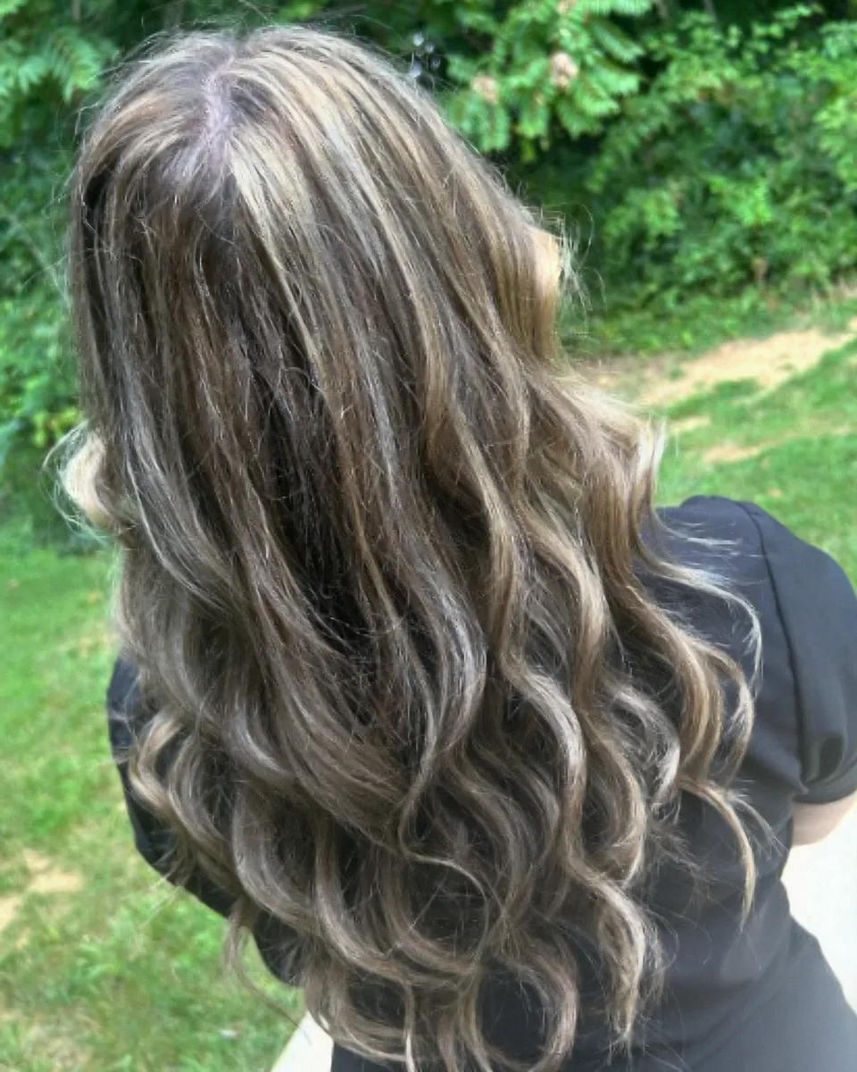 Silver and blonde dimensional color with a finished curl