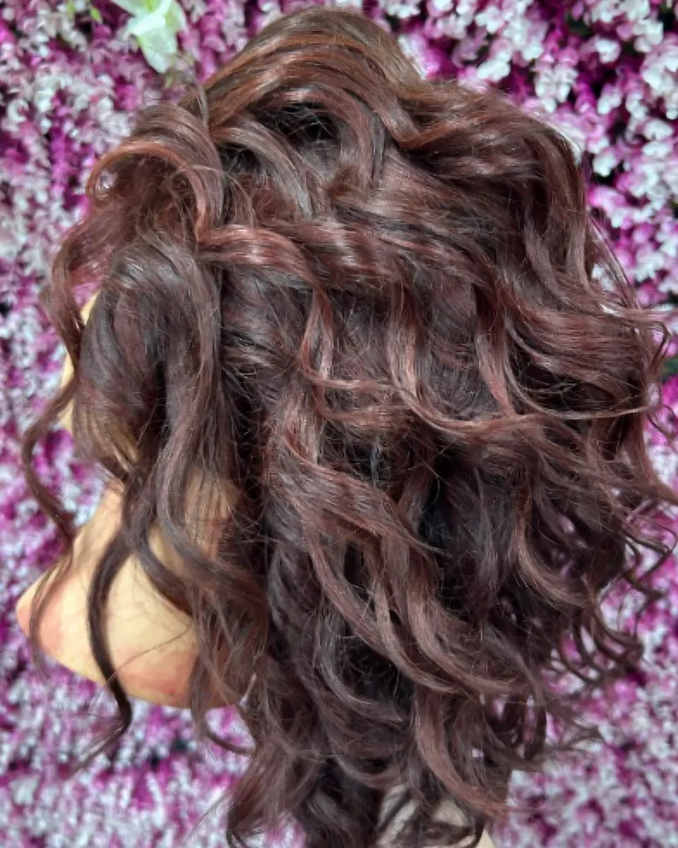 Auburn curl set on a mannequin