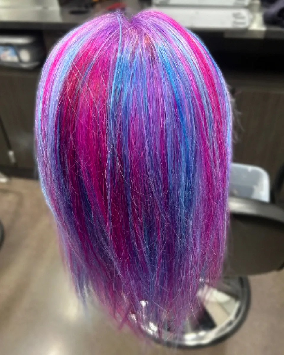 Magenta, violet, and blue weave on a mannequin